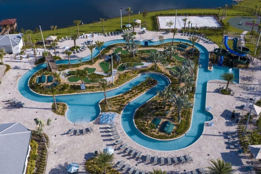 An aerial view of a resort-style swimming pool with a lazy river and miniature golf course — 4830 MEMORIES LANE, KISSIMMEE, FL