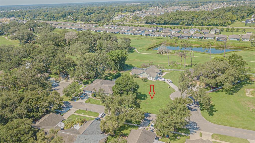An aerial view shows a residential property with a large lawn and a red arrow — BRENTWOOD DRIVE, ZEPHYRHILLS, FL