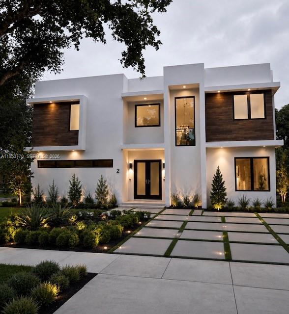 A modern two-story house features white stucco walls, wood accents, and a paved driveway — 2 Hough Dr, Miami Springs FL 33166, MIAMI SPRINGS, FL
