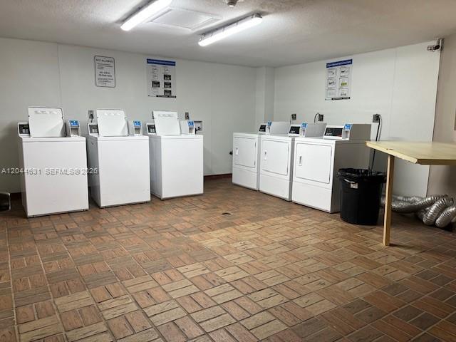 A laundry room features multiple white washing machines and dryers on a brick-tiled floor — 8540 SW 133rd Ave Rd # 123, Miami FL 33183, MIAMI, FL