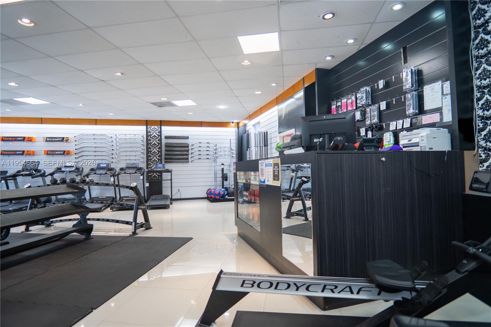 A retail gym equipment store features treadmills, weight racks, and a front service counter — 12253 S Dixie Hwy, Pinecrest FL 33156, PINECREST, FL