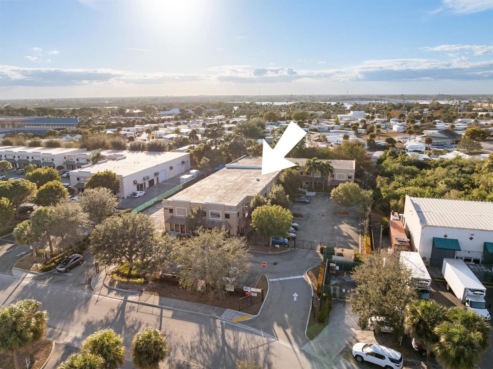 An aerial view shows a two-story commercial building with a flat roof and parking lot — 2580 SE Willoughby Boulevard, Stuart FL 34994, STUART, FL
