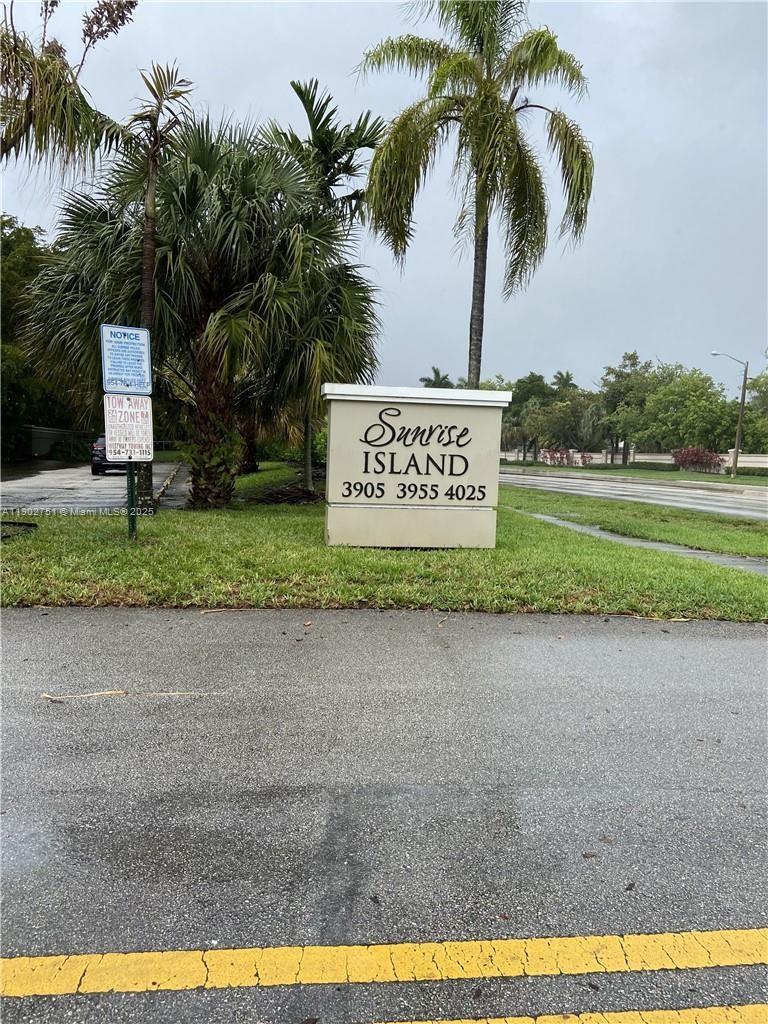 A sign for Sunrise Island stands on a grassy lawn next to a palm tree — 3955 N Nob Hill Rd # 101, Sunrise FL 33351, SUNRISE, FL