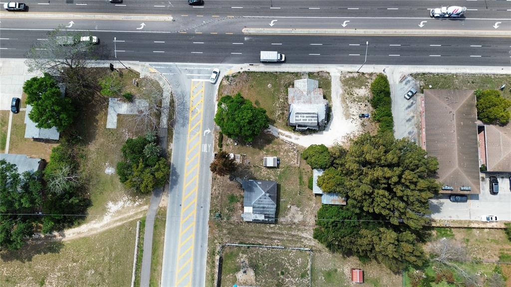 An aerial view shows a road intersection with adjacent residential lots and buildings — 980 S LAKE SHORE WAY, LAKE ALFRED, FL