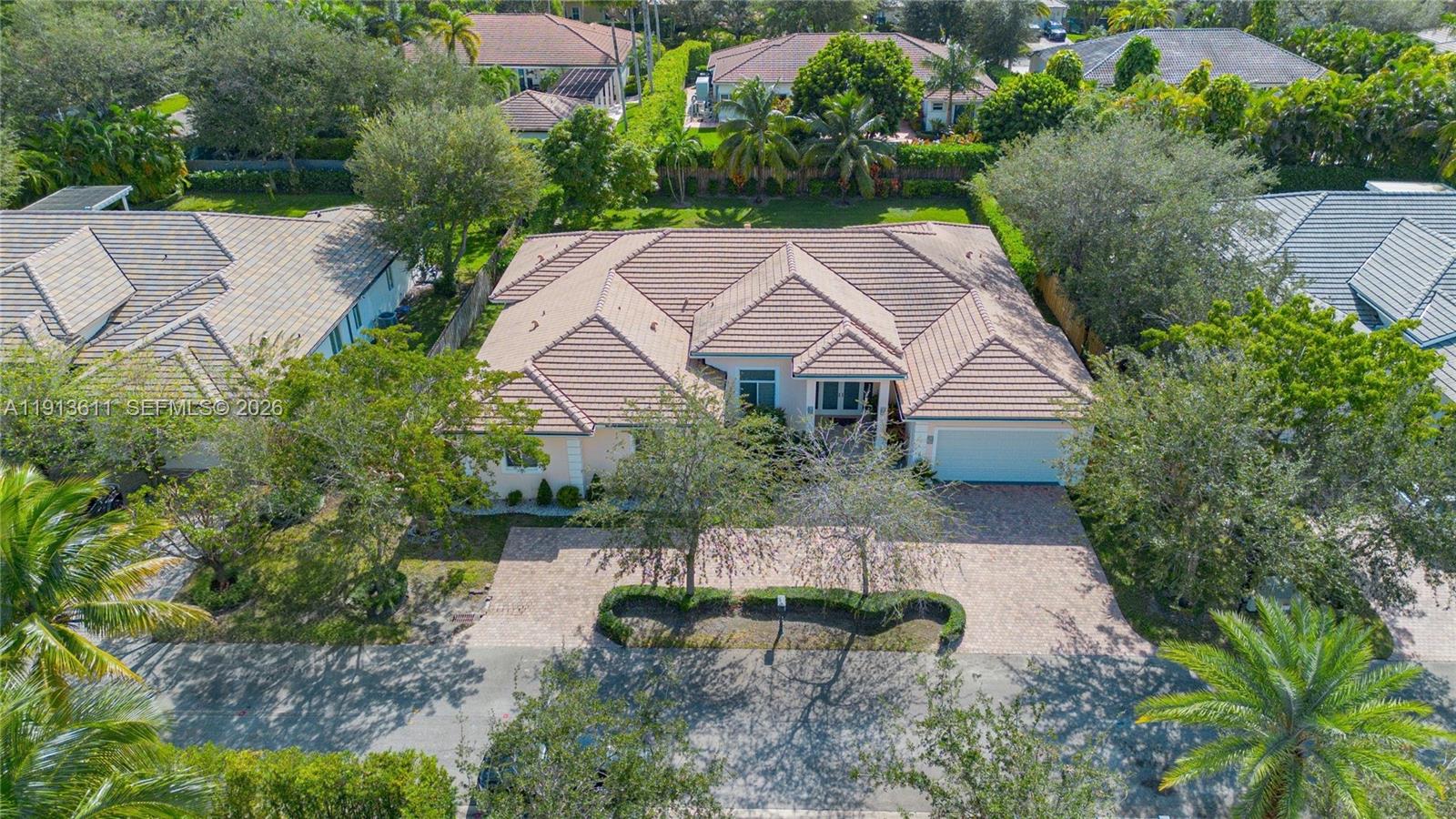 An aerial view shows a single-story house with a tiled roof and paved driveway — 9424 SW 123rd Ter, Miami FL 33176, MIAMI, FL