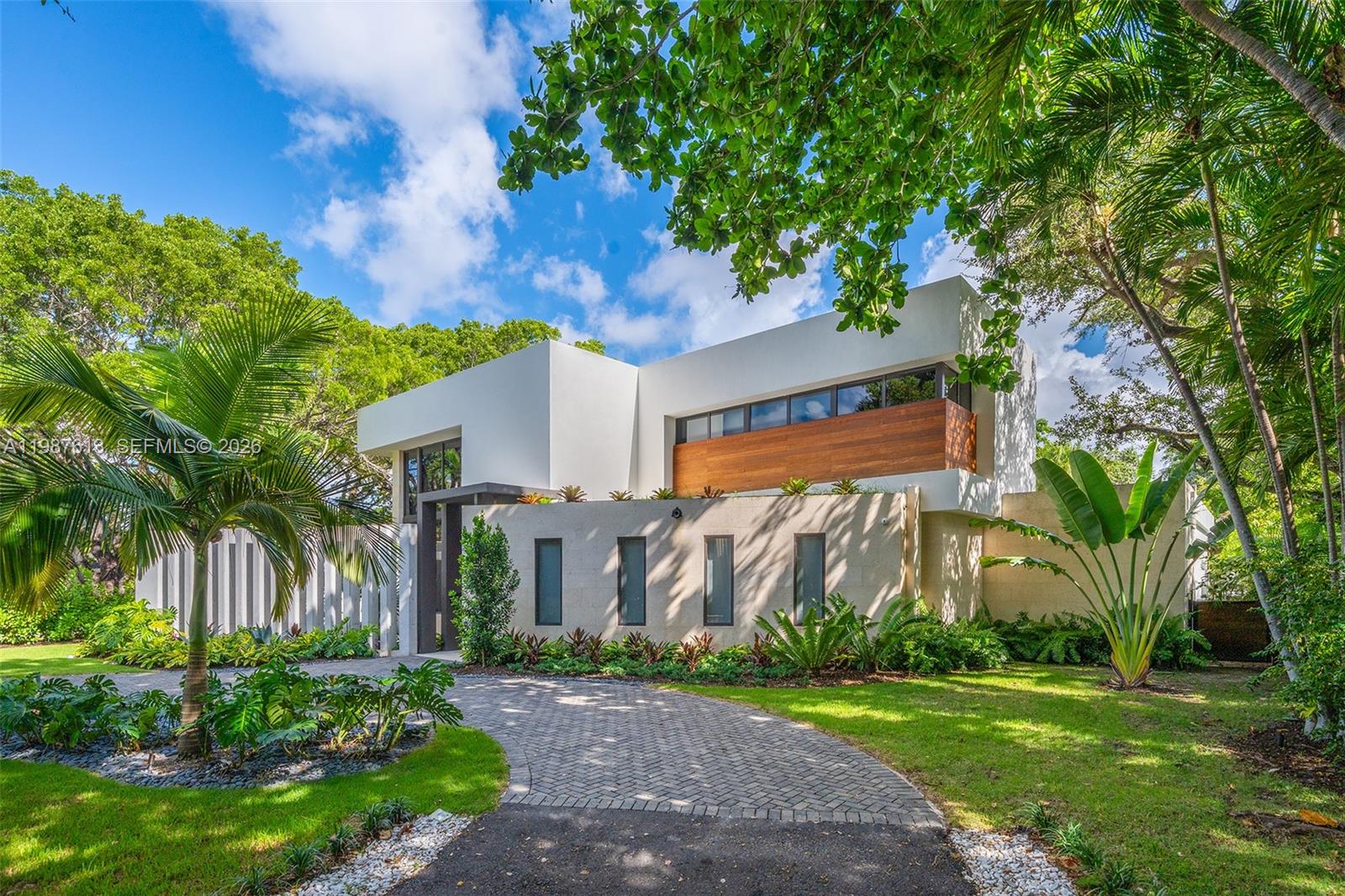 A modern two-story house with white walls, wood accents, and a paved driveway — 4041 S Le Jeune Rd, Miami FL 33146, MIAMI, FL