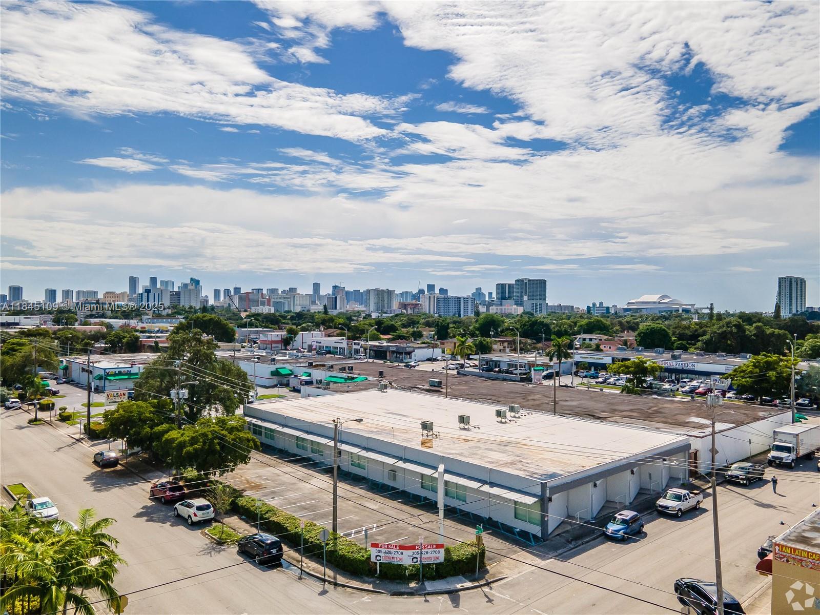 An aerial view shows a commercial building with a flat roof and surrounding parking lots — 2090 NW 21st St, Miami FL 33142, MIAMI, FL