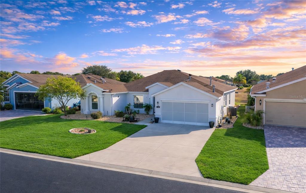 A single-story house with a white exterior, a two-car garage, and a green lawn — 1338 SW 161ST PLACE, OCALA, FL