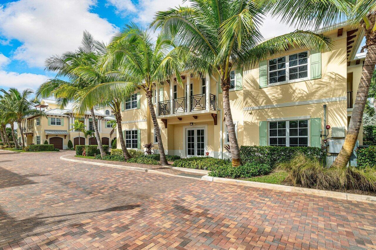 A two-story yellow building with palm trees and a brick-paved driveway in front — 3770 County Line Road # A1, Tequesta FL 33469, TEQUESTA, FL