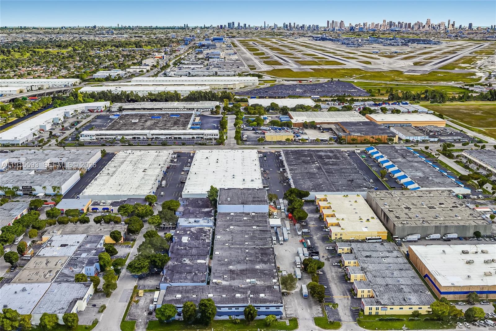 An aerial view shows industrial warehouses and parking lots adjacent to a large airport runway — 3353 NW 74th Ave, Miami FL 33122, MIAMI, FL