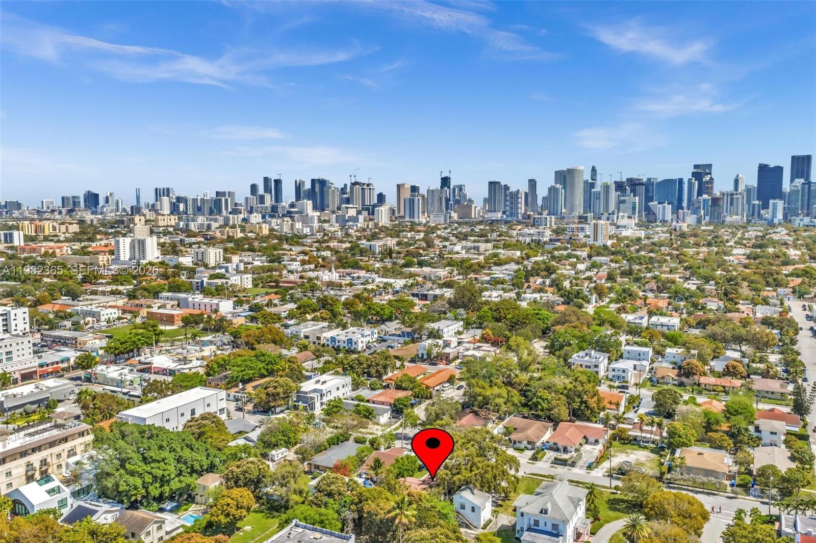 An aerial view of a residential neighborhood with a city skyline in the background — 1010 SW 14th Ave, Miami FL 33135, MIAMI, FL