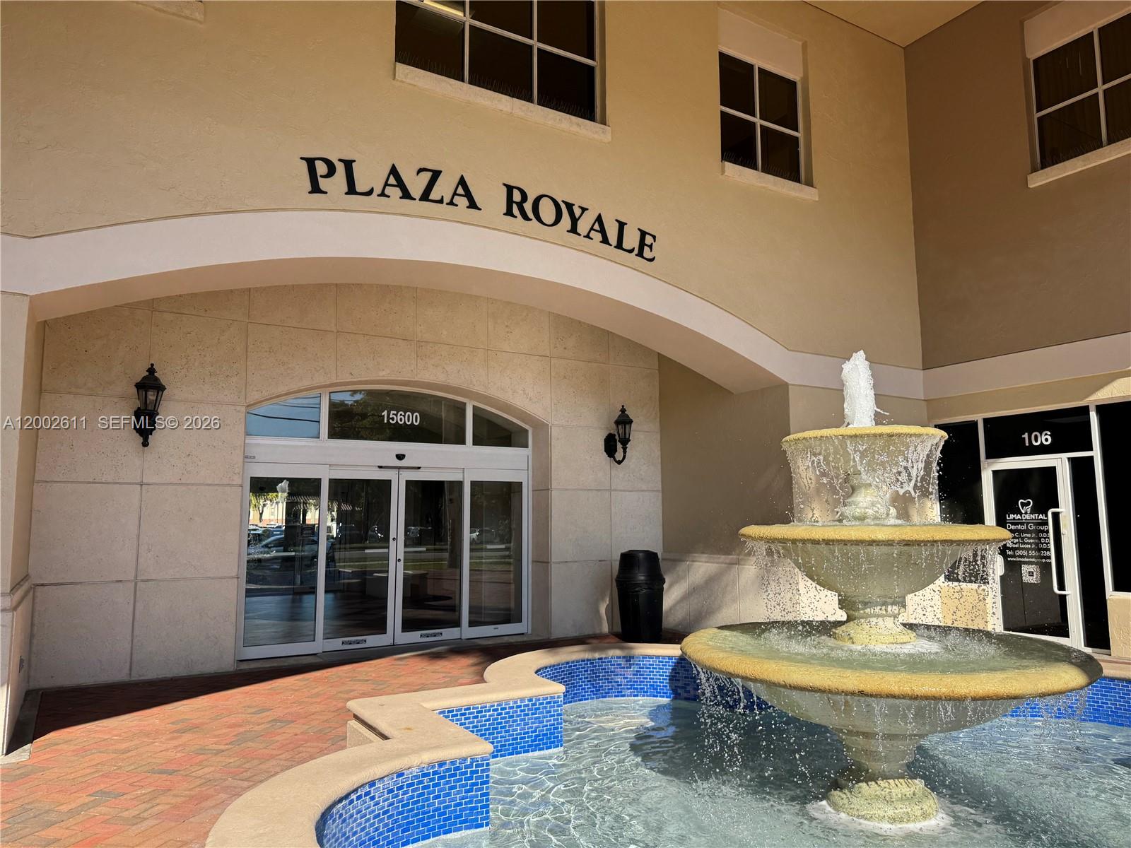 A three-tiered stone fountain sits in front of a building entrance labeled Plaza Royale — MIAMI LAKES, FL