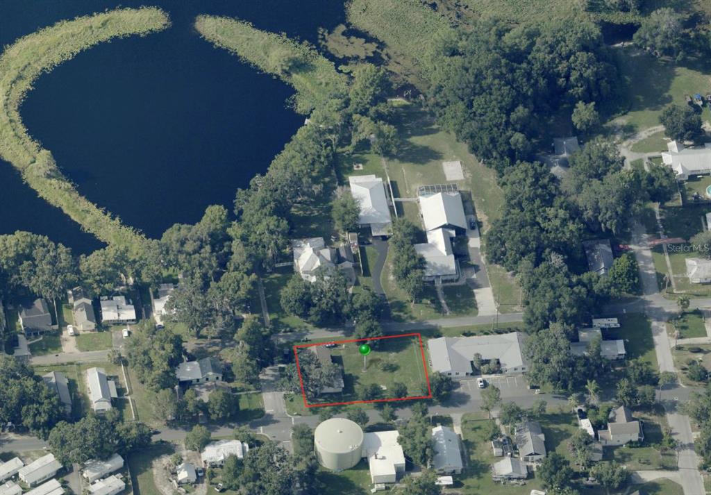 An aerial view shows a rectangular residential lot with a house and trees — 310 N CITRUS AVENUE, INVERNESS, FL