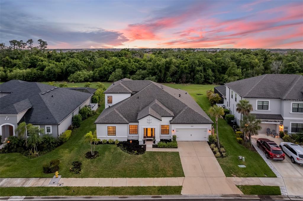 An aerial view of a single-family home with a white exterior and a gray roof — 4520 POND BROOK COURT, LAKEWOOD RANCH, FL