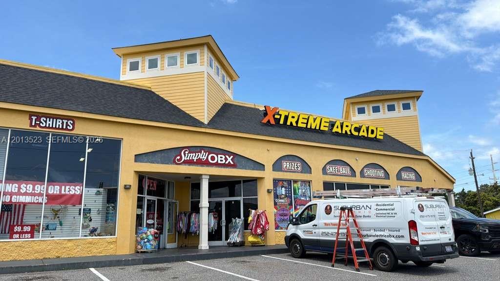 A yellow commercial building features an arcade, a retail store, and a service van parked outside — 40194 Tuna Ter, NC 27915, NC