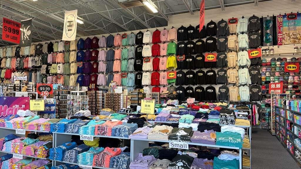 A retail store interior features walls lined with numerous folded and hanging apparel items — 40194 Tuna Ter, NC 27915, NC