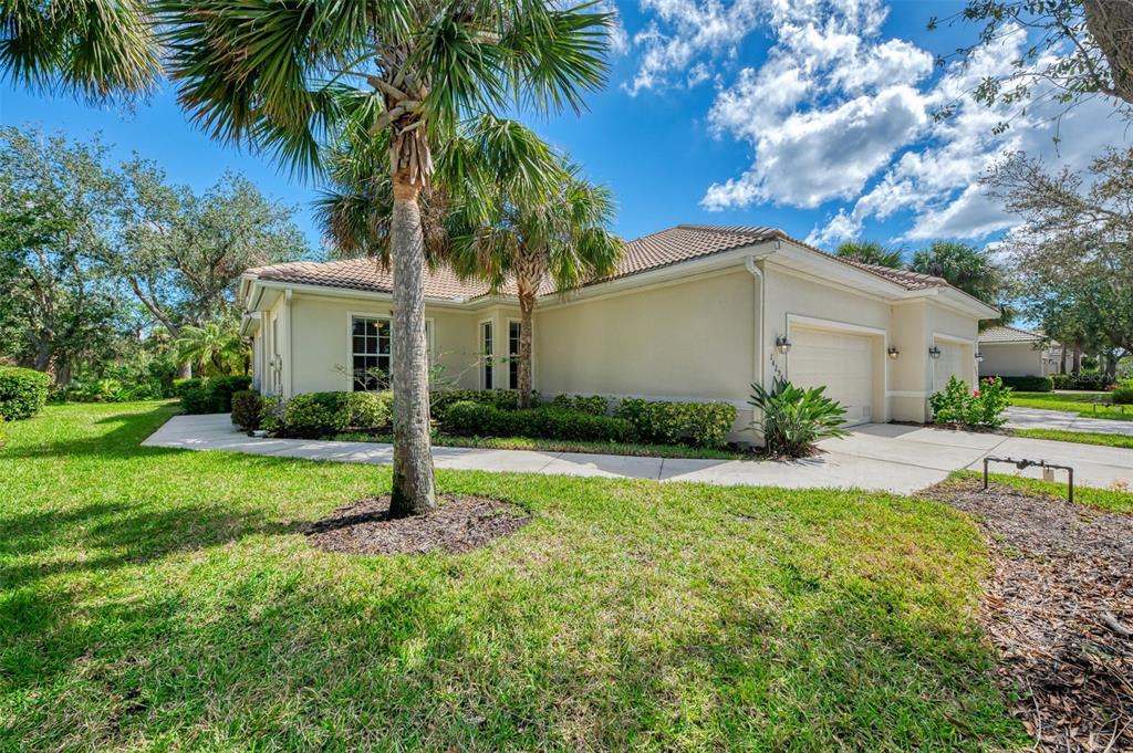 A single-story house with a beige stucco exterior, a tile roof, and a two-car garage — 14298 RESERVE COURT, PORT CHARLOTTE, FL