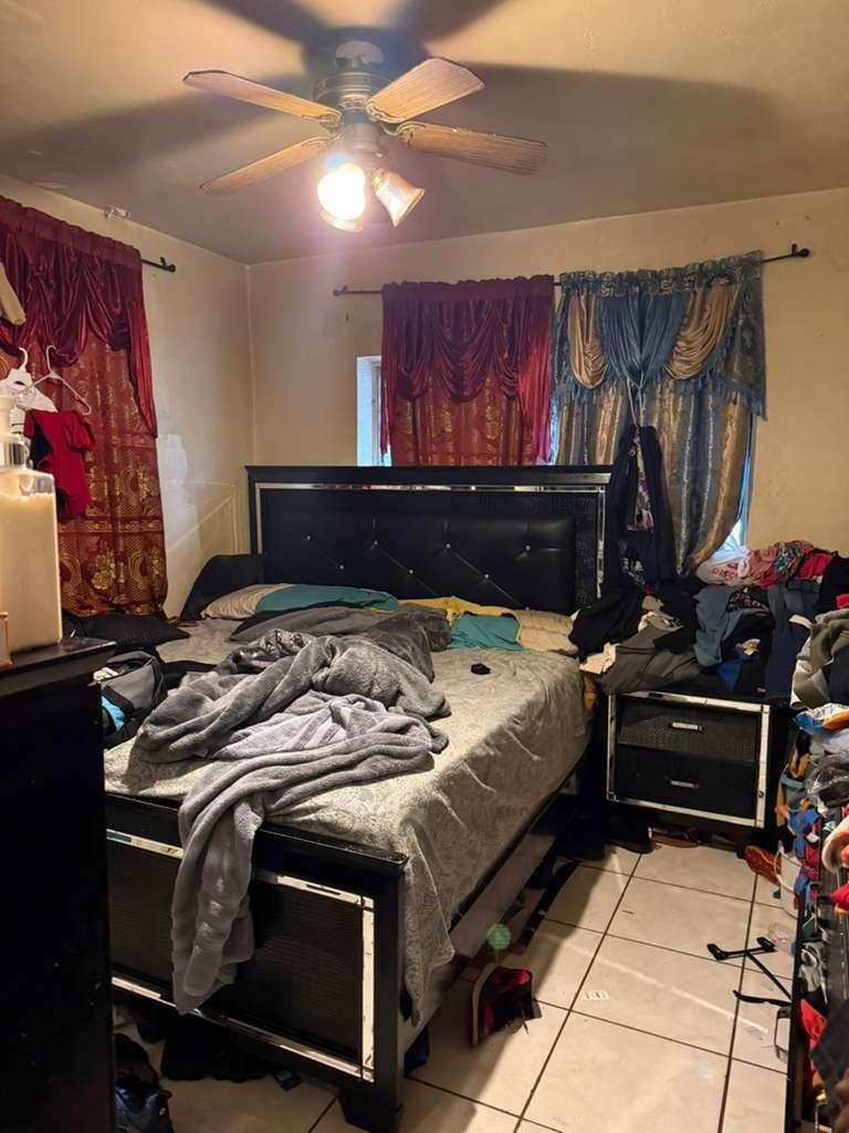 A bedroom features a black tufted headboard, a ceiling fan, and tiled flooring — 139 NE 63rd Street, Miami FL 33138, MIAMI, FL