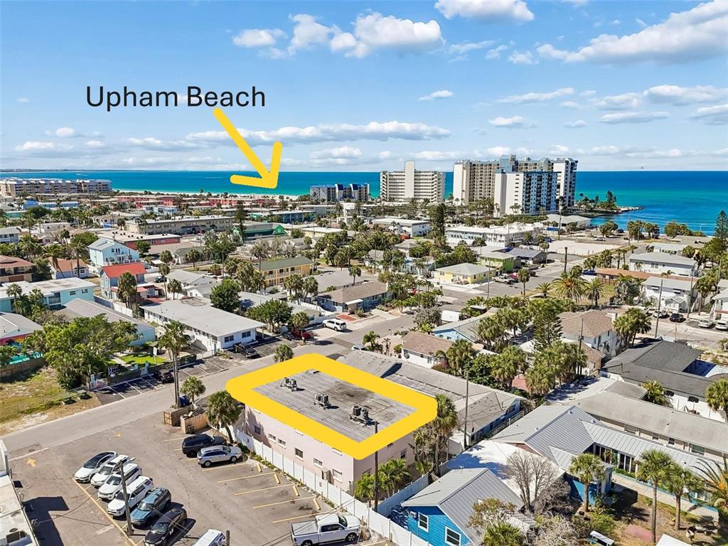 An aerial view shows a multi-story building with a flat roof highlighted in yellow — 525 73RD AVE UNIT 5, ST PETE BEACH, FL