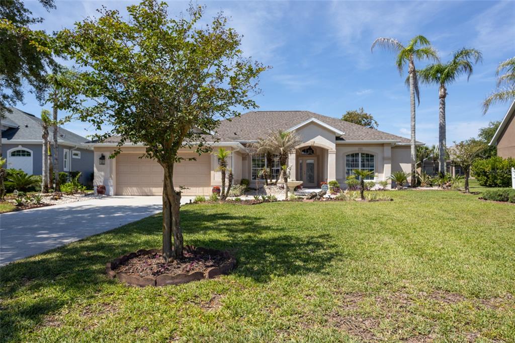 An aerial view shows a residential neighborhood with houses, a lake, and a yellow arrow — 6 S LAKEWALK DRIVE, PALM COAST, FL