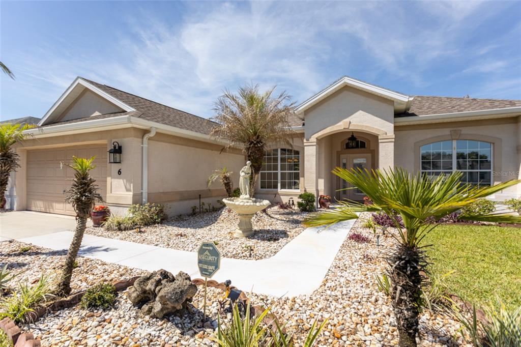 An aerial view of a single-story suburban house with a brown roof and pond — 6 S LAKEWALK DRIVE, PALM COAST, FL