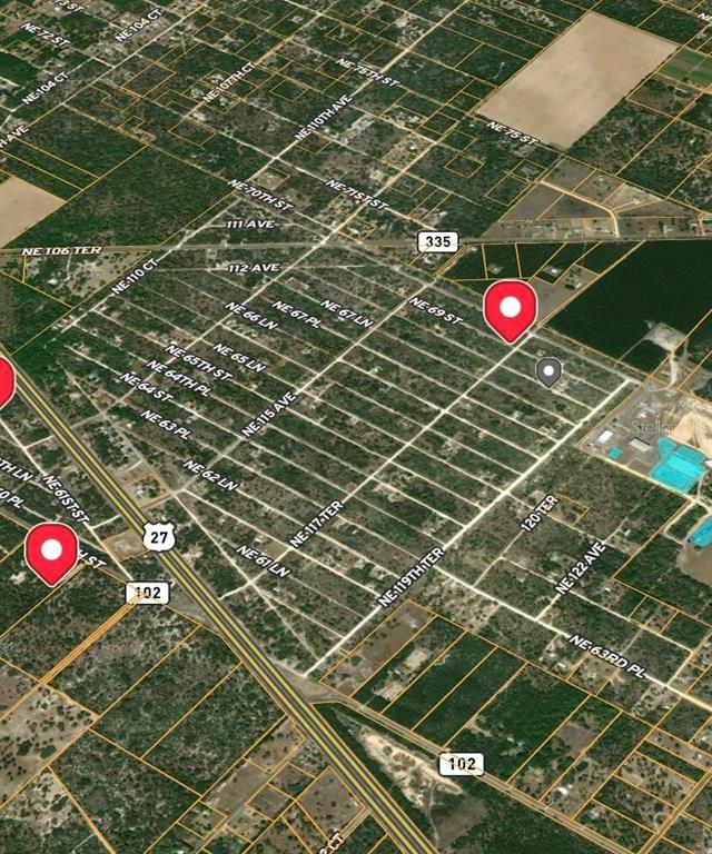 This is an aerial map showing a grid of streets and land parcels — NE 69TH STREET, WILLISTON, FL
