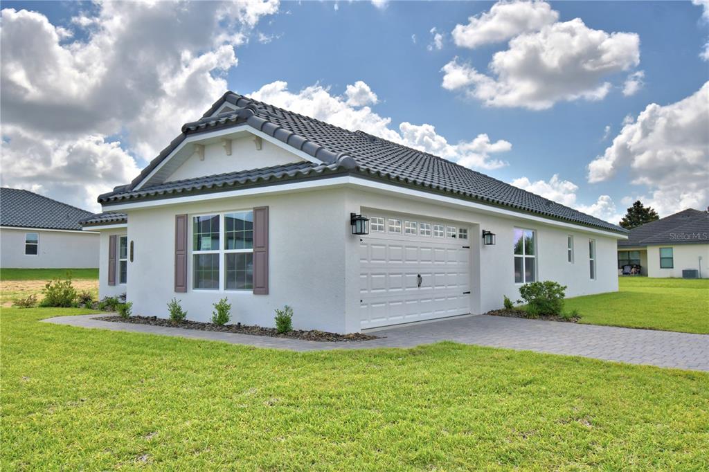 A white stucco house with a tiled roof, a two-car garage, and brown shutters — 4502 GRANDVIEW GLEN DRIVE, AUBURNDALE, FL