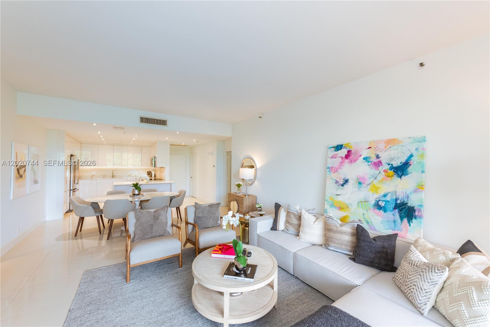 A bright living room features a sectional sofa, two armchairs, a coffee table, and an adjacent dining area — 251 Crandon Blvd # 227, Key Biscayne FL 33149, KEY BISCAYNE, FL