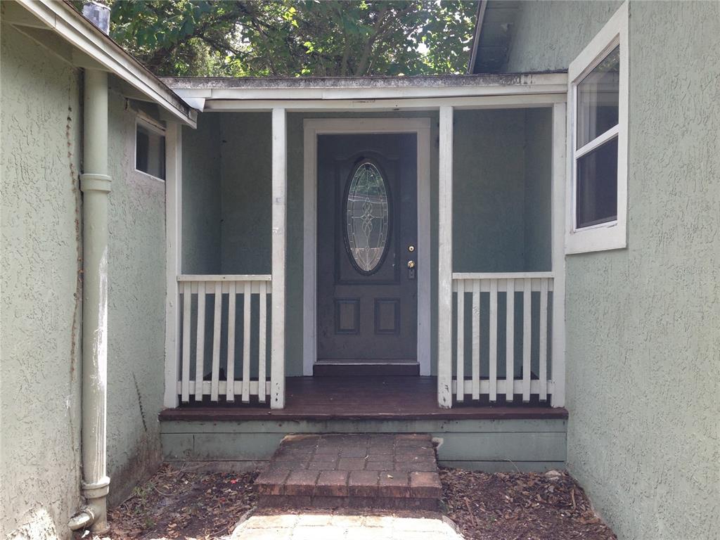 A front porch with a dark door, white railings, and a brick walkway — 1328 CLOVERLAWN AVENUE UNIT B, ORLANDO, FL