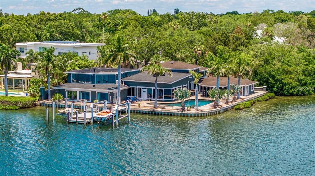 A waterfront house with a private dock, swimming pool, and lush landscaping — 2785 BAYSIDE DRIVE S, ST PETERSBURG, FL