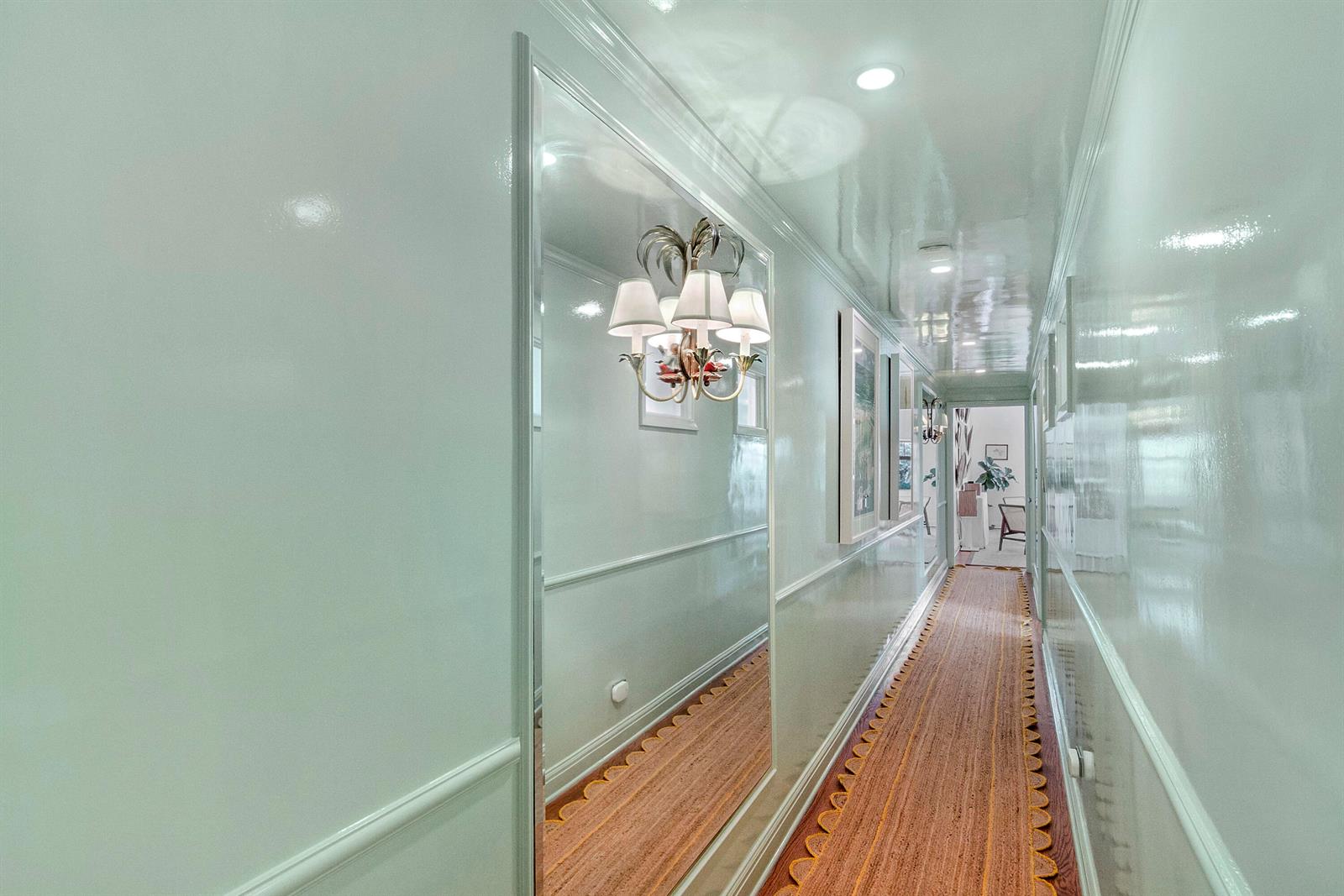 A narrow hallway features high-gloss light green walls, a mirrored section, and a patterned runner — 311 Cocoanut Row # 2010, Palm Beach FL 33480, PALM BEACH, FL