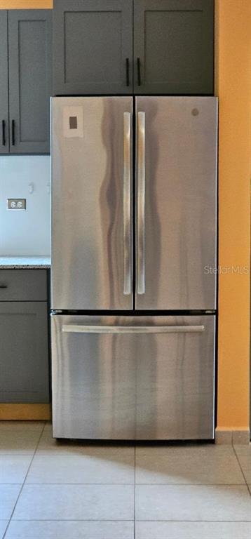 A stainless steel French door refrigerator is positioned between dark gray kitchen cabinets — Apt A-2 Ponciana Condo CARR 413 KM.4.1, RINCON, PR