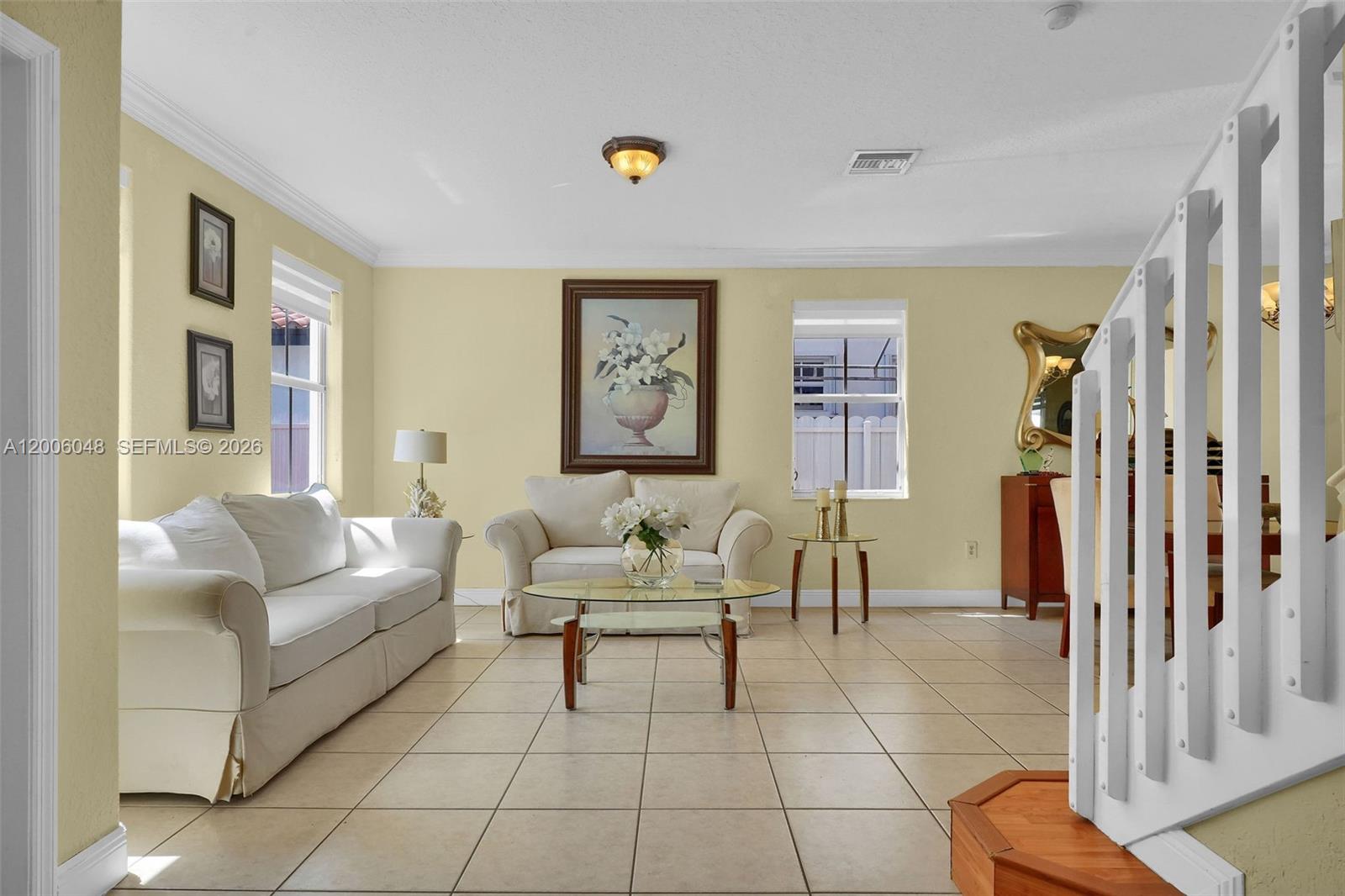 A living room features light yellow walls, tile flooring, white sofas, and a central coffee table — 6114 SW 158th Pass, Miami FL 33193, MIAMI, FL