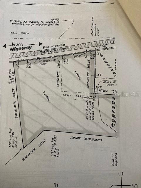 This is a land survey map showing the boundaries and dimensions of two parcels of land — 18040 GUNN HIGHWAY, ODESSA, FL