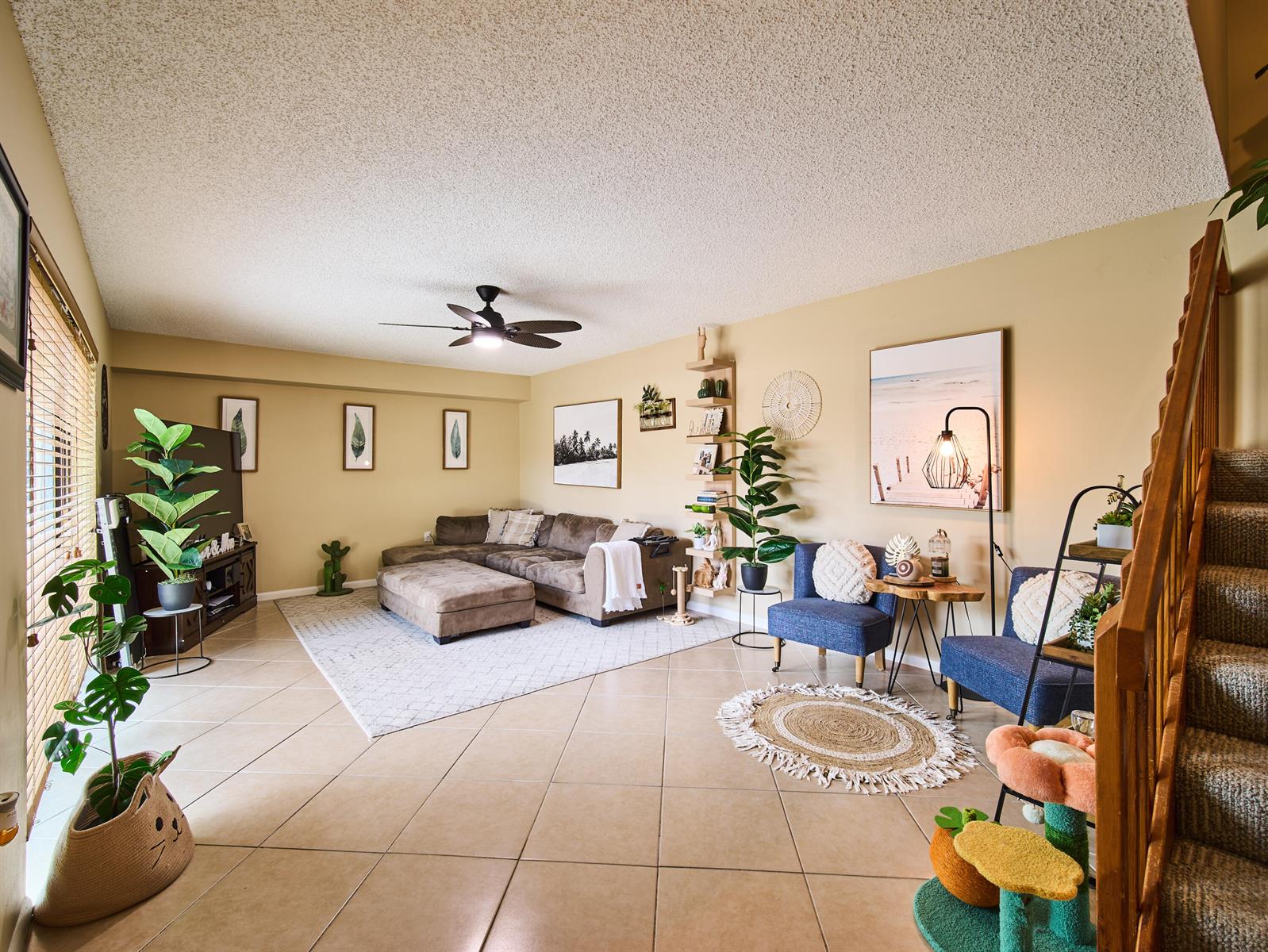 A living room with tile floors, a brown sectional sofa, and two blue accent chairs — 3113 31st Way, West Palm Beach FL 33407, WEST PALM BEACH, FL