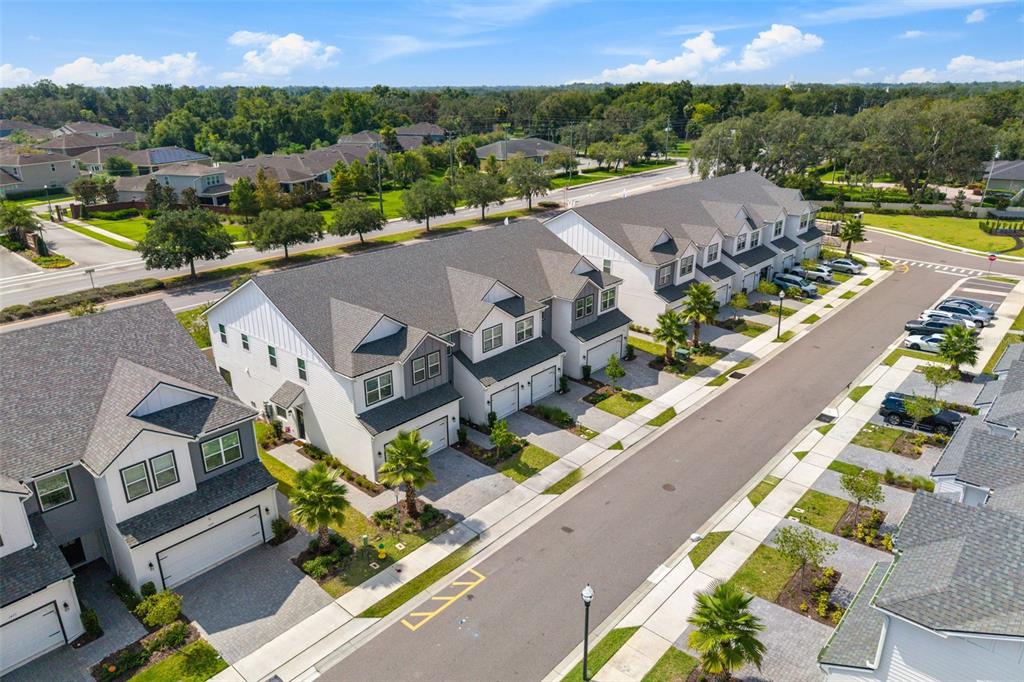An aerial view shows a community swimming pool with a covered patio and surrounding landscaping — 1445 BROOKDALE COURT, OVIEDO, FL