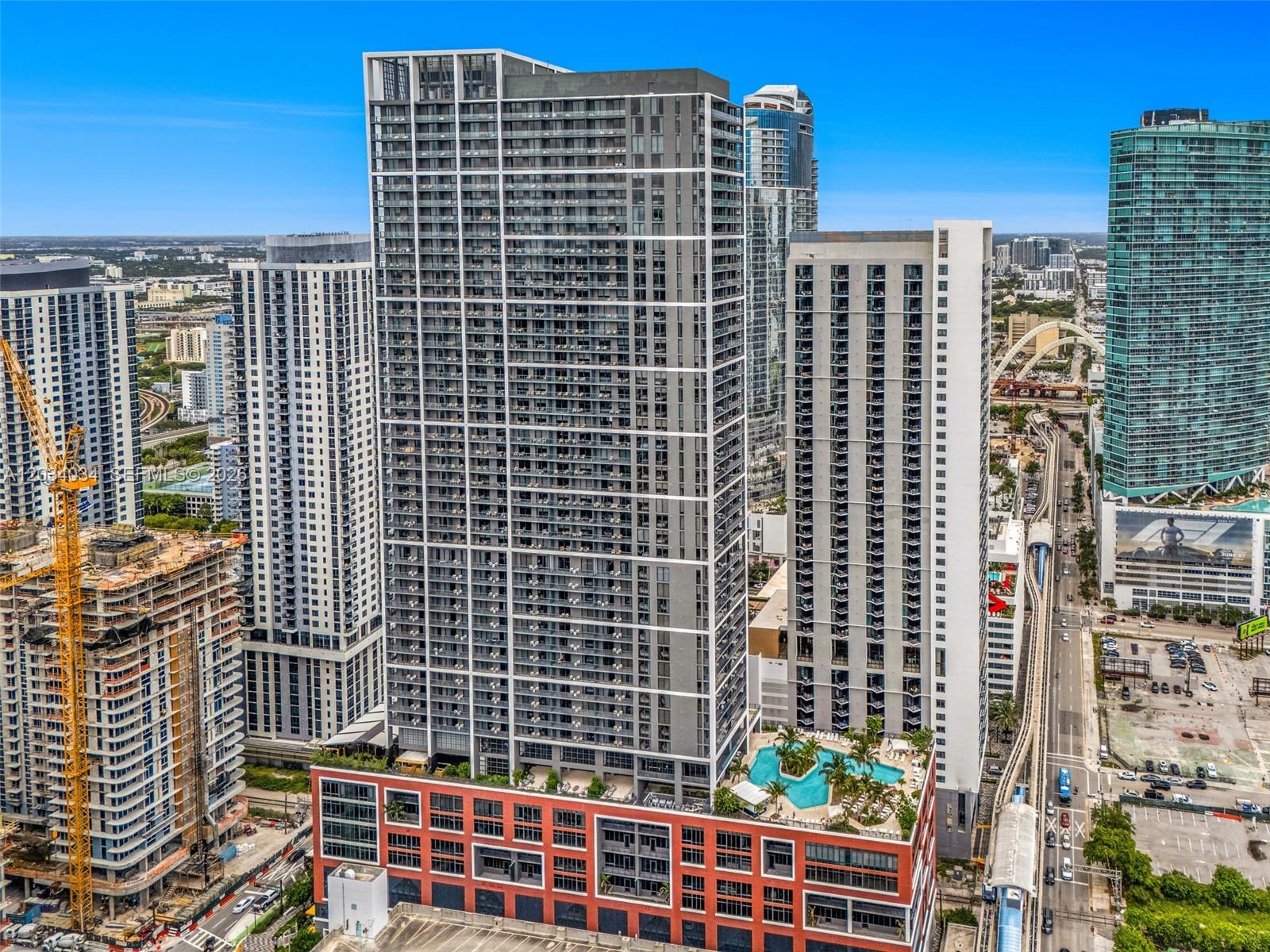 An aerial view shows several tall modern apartment buildings and a swimming pool deck — 601 NE 1st Ave # 4814, Miami FL 33132, MIAMI, FL