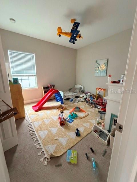 A child's bedroom features a yellow patterned rug, a red slide, and a toy airplane — 9362 WOODCRANE DRIVE, WINTER GARDEN, FL