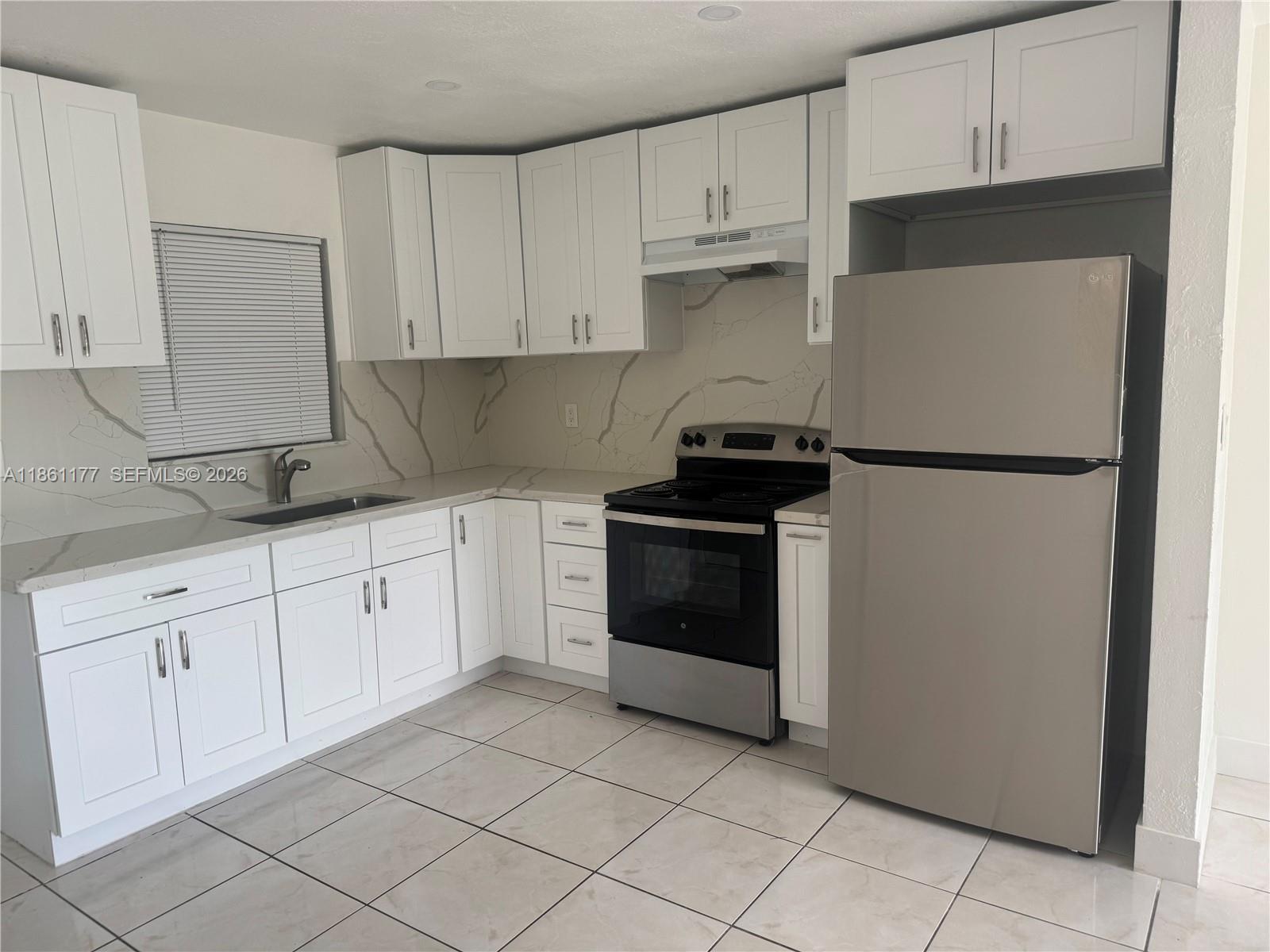A single-story building with a concrete parking lot and a white metal fence — 732 SW 6th St # 732, Dania Beach FL 33004, DANIA BEACH, FL