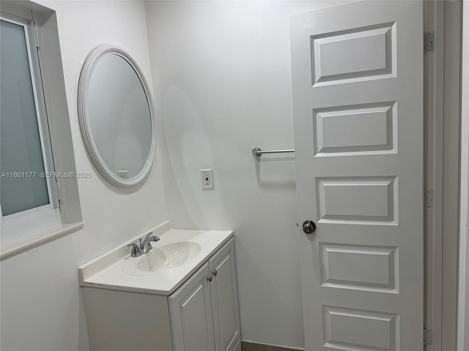 A kitchen features white cabinets, stainless steel appliances, and marble-patterned countertops and backsplash — 732 SW 6th St # 732, Dania Beach FL 33004, DANIA BEACH, FL