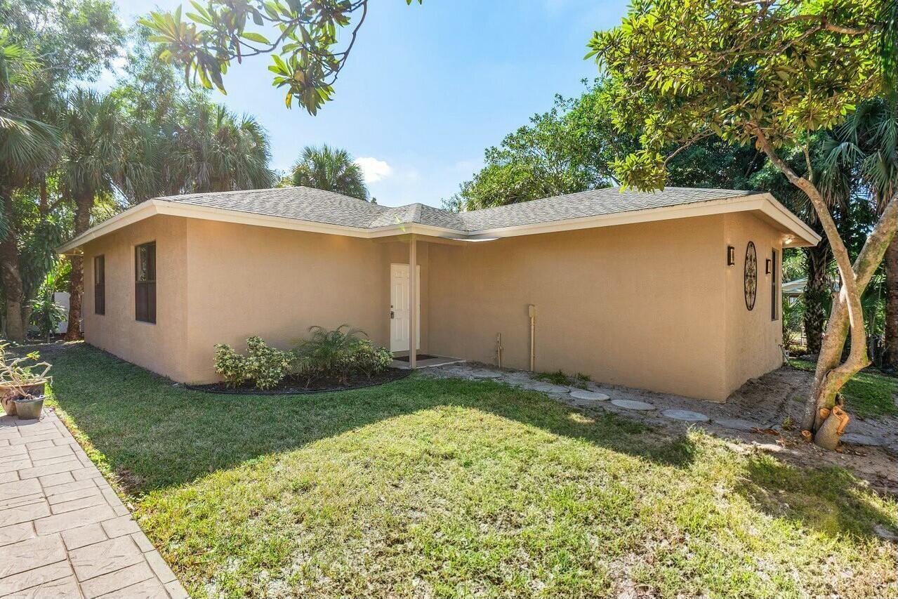 A tan, single-story house with a hip roof and a small covered entryway — 9266 Pinion Drive, Lake Worth FL 33467, LAKE WORTH, FL