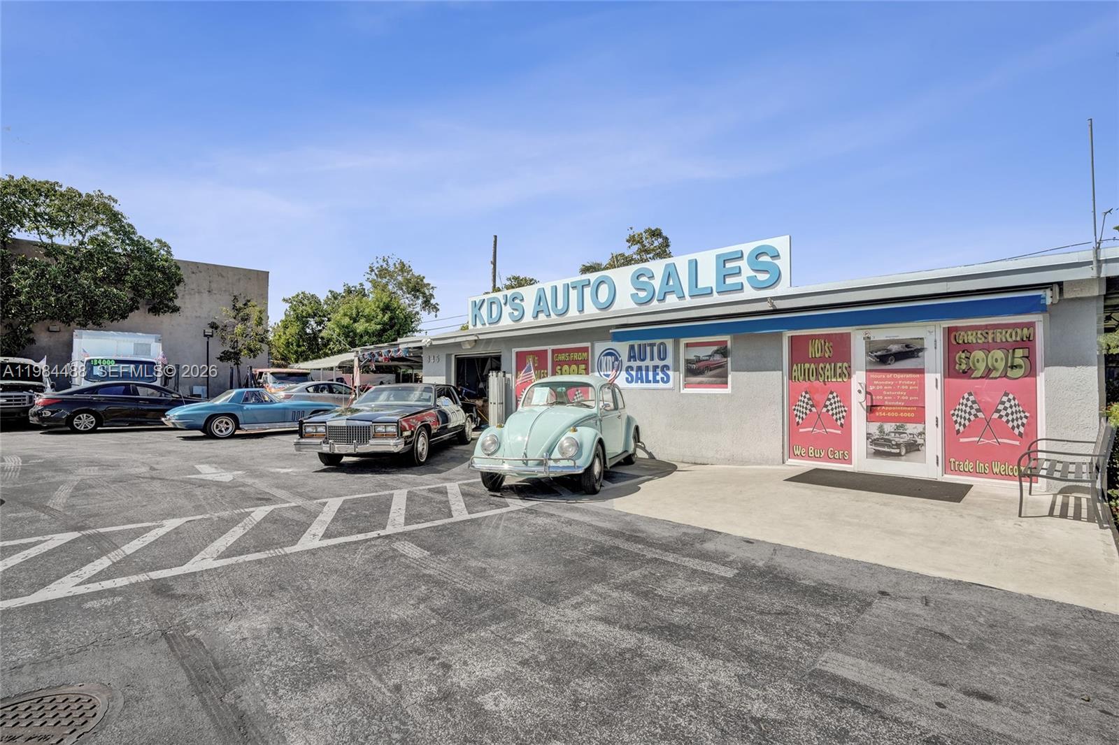 The exterior of a car dealership features a light blue Volkswagen Beetle parked in front — 345 COPANS RD, Pompano Beach FL 33064, POMPANO BEACH, FL