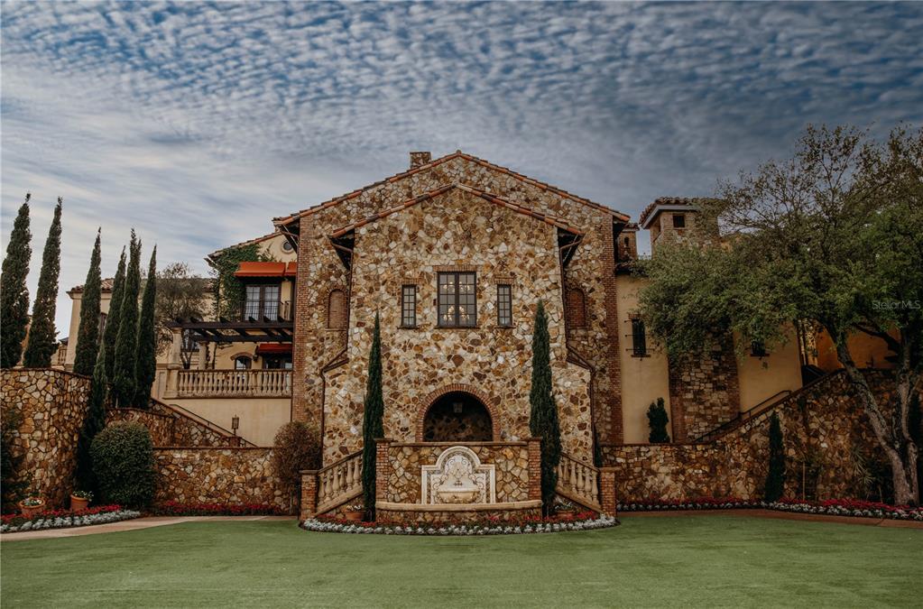 A stone-clad Mediterranean-style mansion features a central fountain, arched entryway, and manicured lawn — 15414 APENNINE WAY, MONTVERDE, FL