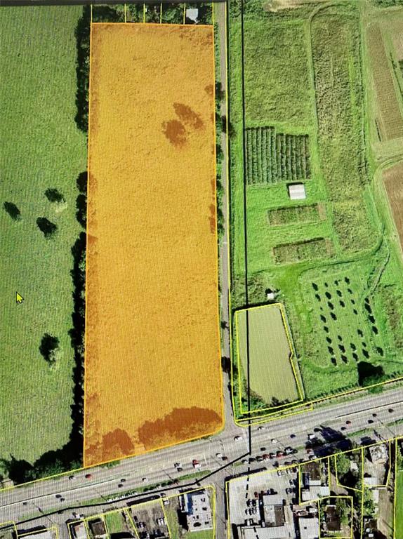 This aerial map shows a rectangular plot of land highlighted in yellow next to a road — PR 2 KM. 115.5, AGUADILLA, PR
