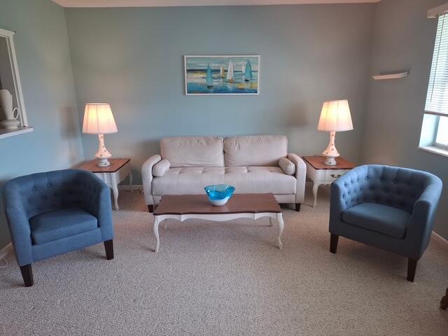 A living room features a beige sofa, two blue armchairs, and a coffee table — 620 Horizon W # 202, Boynton Beach FL 33435, BOYNTON BEACH, FL
