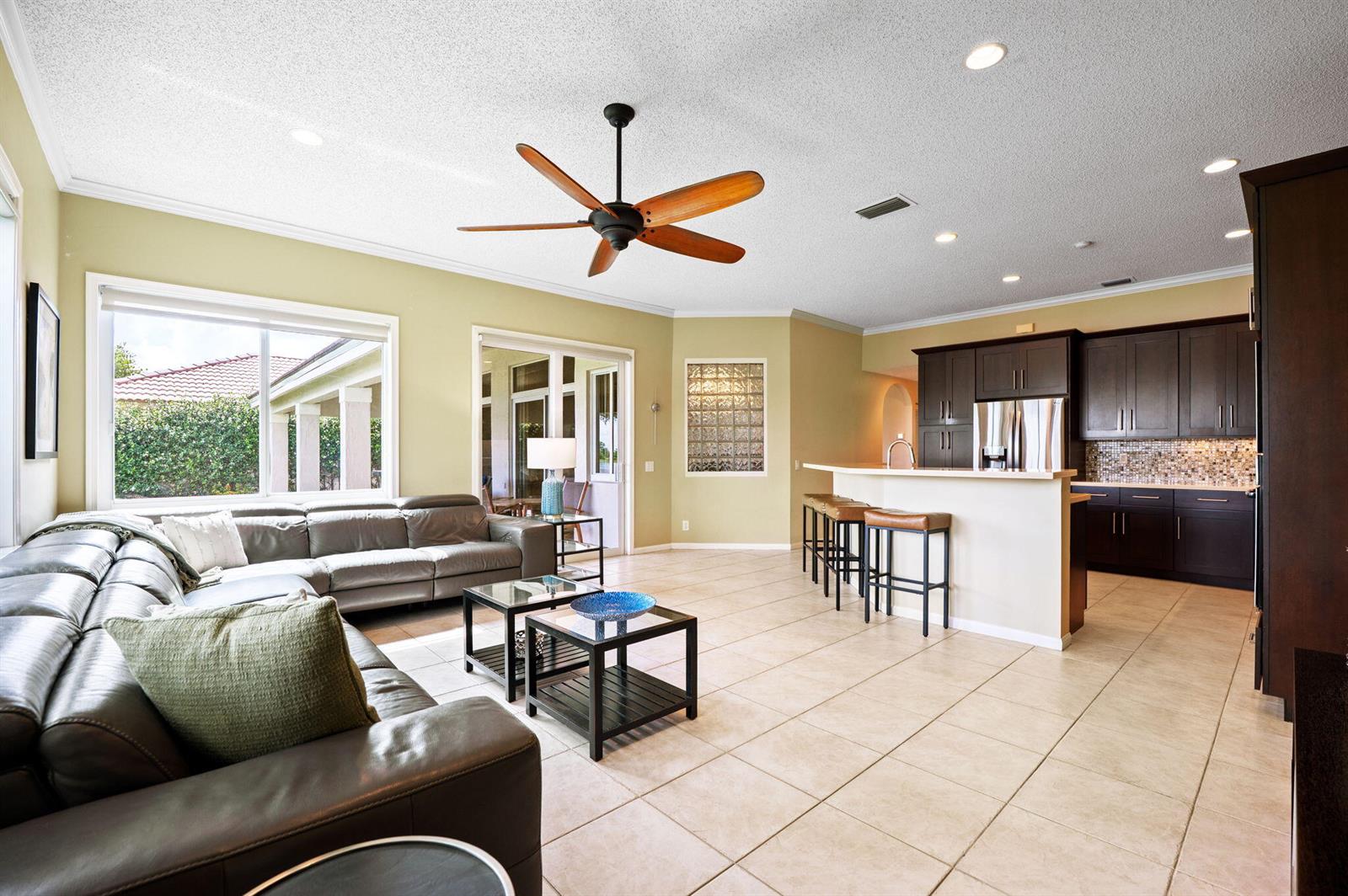 A single-story house with a beige stucco exterior, a paved driveway, and mature trees — 804 Heritage Drive, Weston FL 33326, WESTON, FL