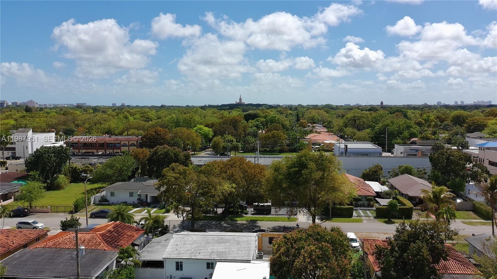 An elevated view shows a residential neighborhood with houses, trees, and a distant skyline — 5410 SW 5th Terr, Miami FL 33134, MIAMI, FL