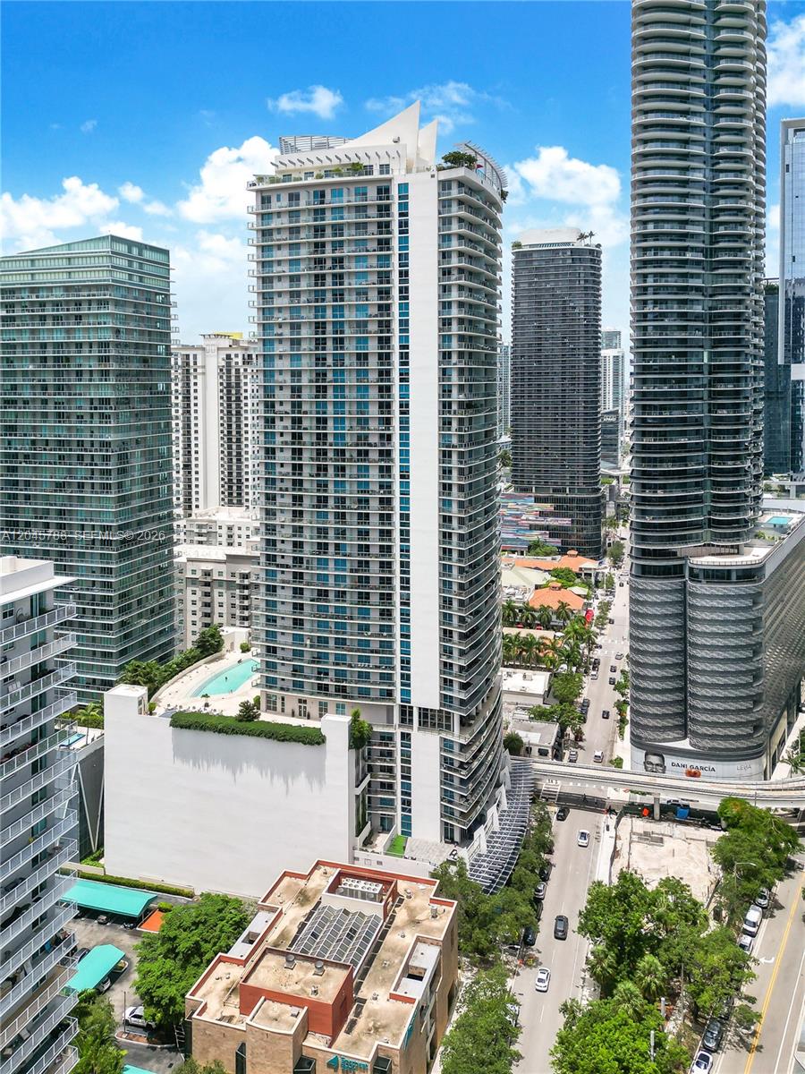 An aerial view shows several tall, modern residential skyscrapers in a dense urban setting — 1100 S Miami Ave # 1607, Miami FL 33130, MIAMI, FL