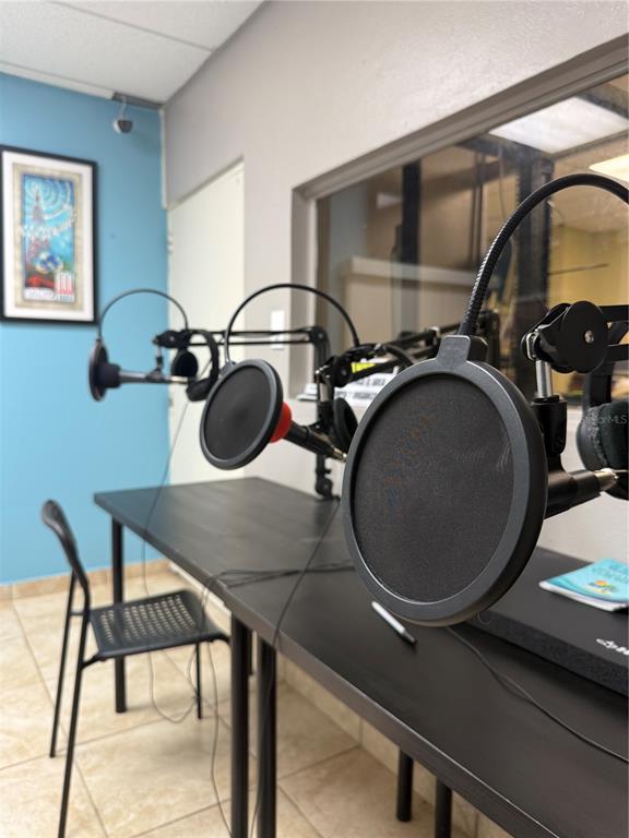 A podcast recording room features two microphones with pop filters on a black desk — PR-306 K0 H7 PALMAREJO WARD, LAJAS, PR