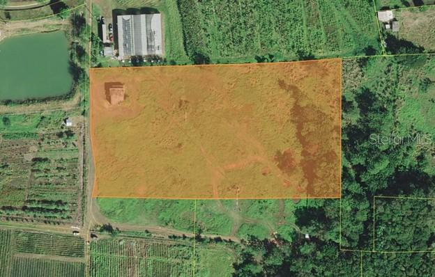 An aerial view shows a rectangular plot of land highlighted in orange — PR-306 K0 H7 PALMAREJO WARD, LAJAS, PR